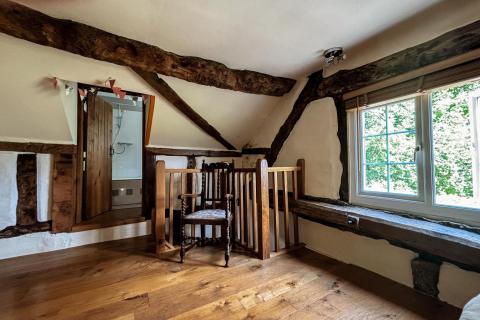 View of guest bedroom with window and step into en-suite shower room