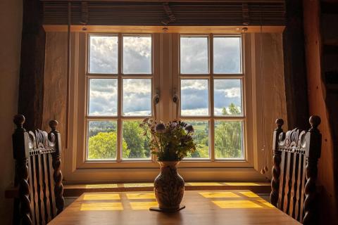 View of table and two chairs in guest lounge with view from window