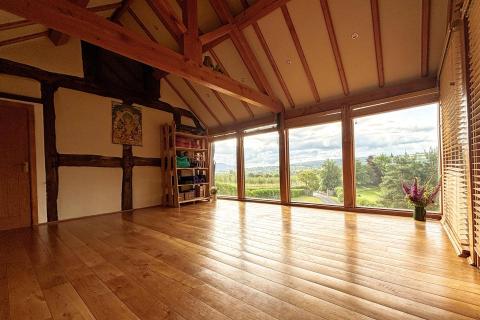 Oak frame and floored room with countryside views