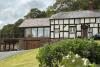 Timber framed house with vegetable plot in foreground