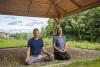 Two people meditating in gazebo