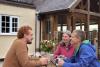 Three people around picnic table