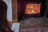 Lady reading by log fire